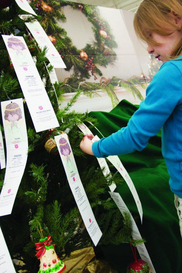 Annalise Teeter surveys the angel tree at Wal-Mart in Florence and tries to decide which child to buy presents for.