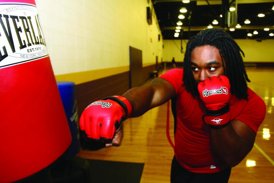 KC Cooper focuses in on a punching bag during a training routine in the SRC.