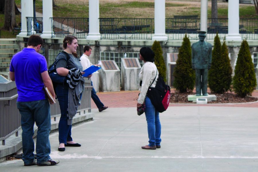 UNA students stand on the bridge near the Amphitheater. A new report said students of differents ethnicities have varying rentention and graduation rates.