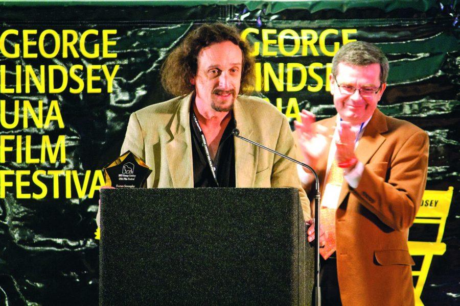 Dr. Greg Pitts applauds D.H. Martin, “Feature Screenplay” winner at the 2011 George Lindsey UNA Film Festival.