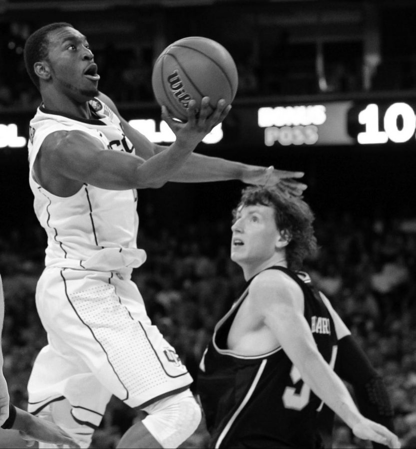 Star UConn pllayer Kemba Walker flies past Matt Howard of Butler on his way to a layup. Walker averaged 24 points a game in the tournament and helped lead his team to the National Championship.