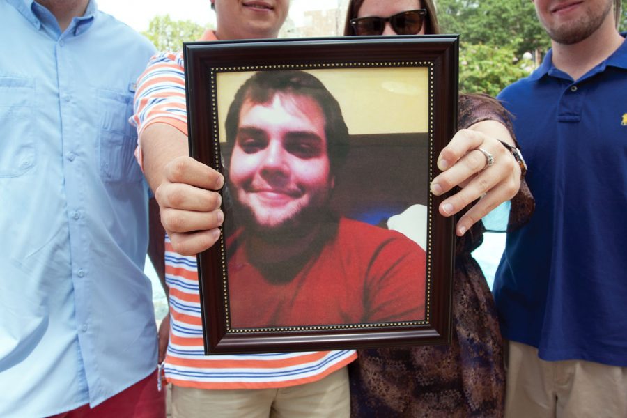 (From left to right) Barrett Parnell, Tabb Sanford, Casey
Weatherbee and Adam Sayre hold a photo of Daniel Smith, a former
UNA student who died in June while kayaking at Cypress Creek.

