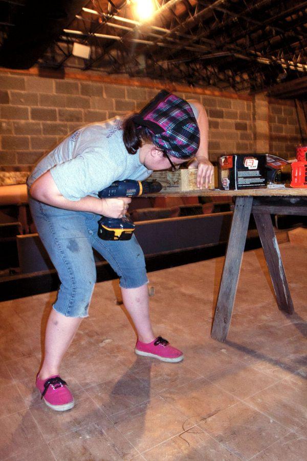 Brittany Flory, technical director for The End theater, gets her
hands dirty doing renovations.
