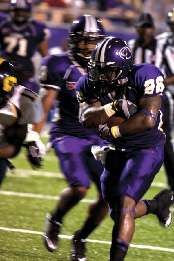 Running back Chris Coffey runs the ball down the field for the
UNA Lions.
