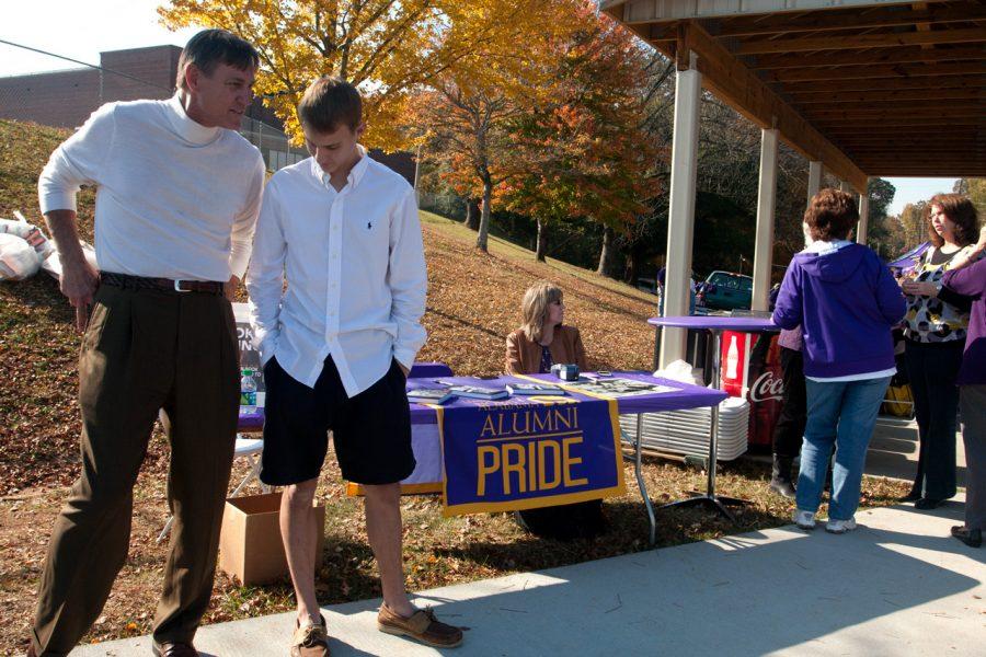 Robert Steele stands in front of his book signing table with his
son Travis, who is a UNA student.
