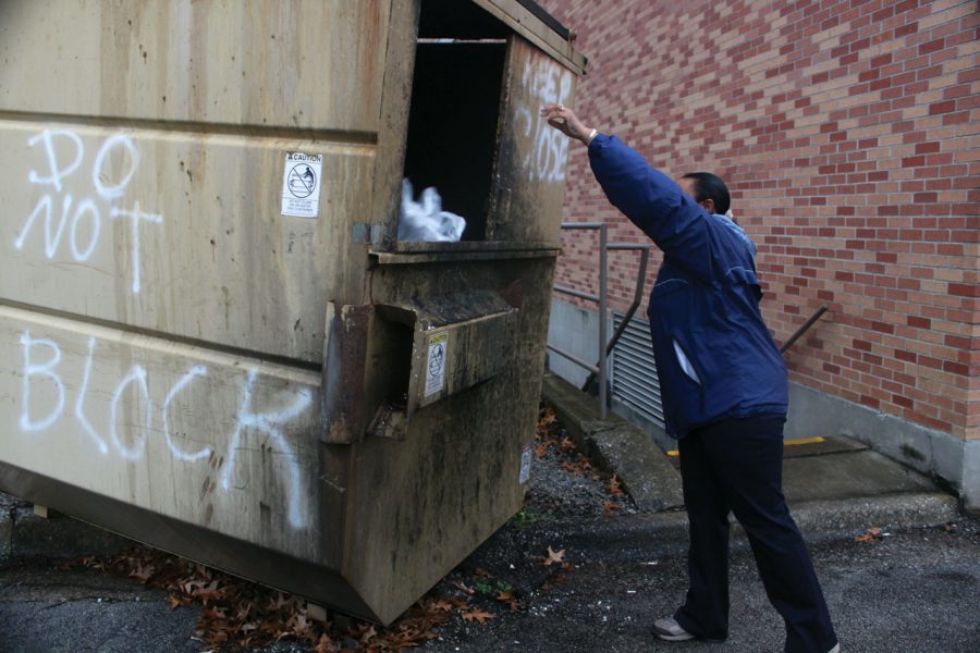 A UNA custodial worker tosses waste into a dumpster on campus.
UNA, among many other entities in the Shoals, produces a
significant percentage of the solid waste thrown away at the
Florence Landfill.
