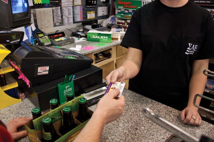 A UNA student purchases beer with his MANE card at Lil’ Steves. Currently, students at UNA can shop at off-campus locations with their cards.
