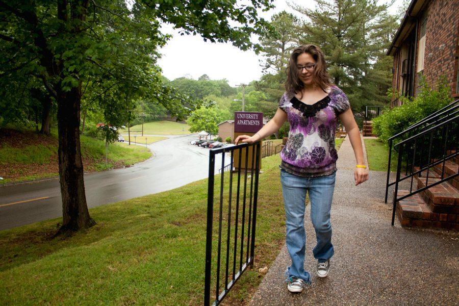 UNA student Brooke Weckwarth navigates the sidewalks in front of her apartment on campus. Weckwarth, who has cerebal palsy, worked with university officials in order to get the railing put in her apartment more easily. 
