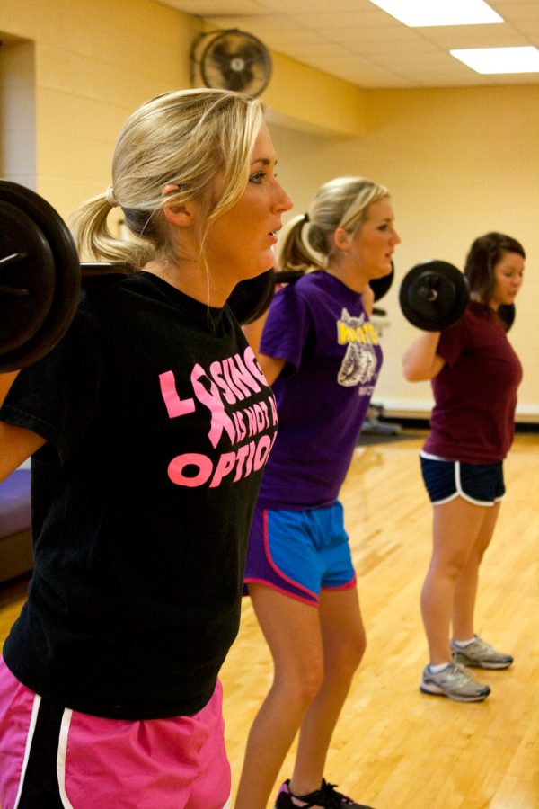 Front to back: Tiffany Ferguson, Alli Ferguson and Nikki Messer do squats during a group exercise class at the Student Recreation Center.
