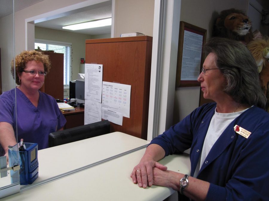 Susan Glasso (left), health services specialist and Cindy Wood (right), executive director, discuss the day’s business in the Health and Wellness Center on campus. Wood has worked in the wellness center for 11 years.
