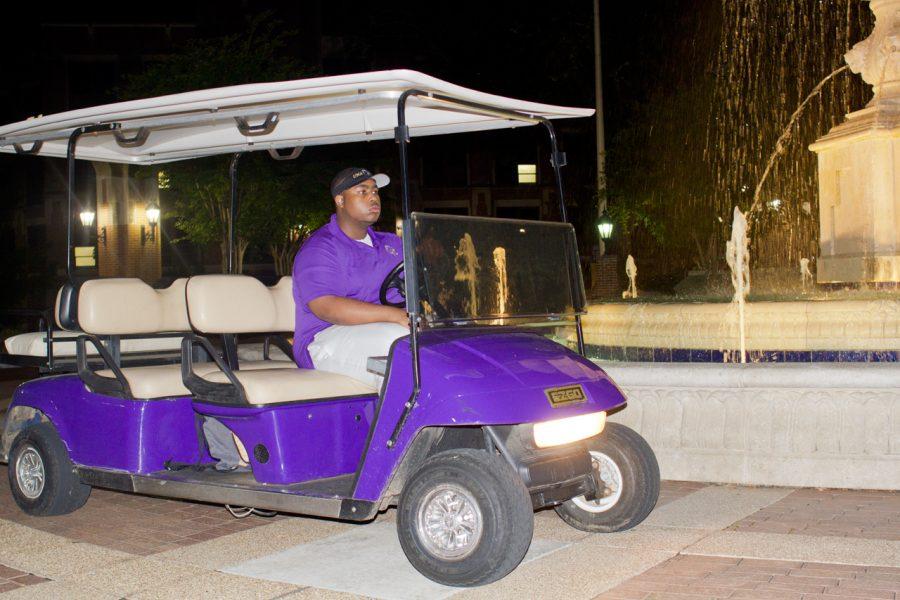 SNAP member Tyrie Fletcher patrols campus in a university police golf cart. 
