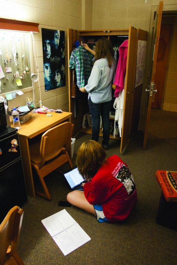 Students hang out in their dorm room on campus. 
