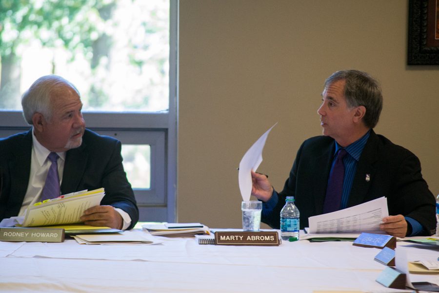 Board President Pro Tem Rodney Howard and Trustee Marty Abroms discuss agenda items during the September board meeting. 
