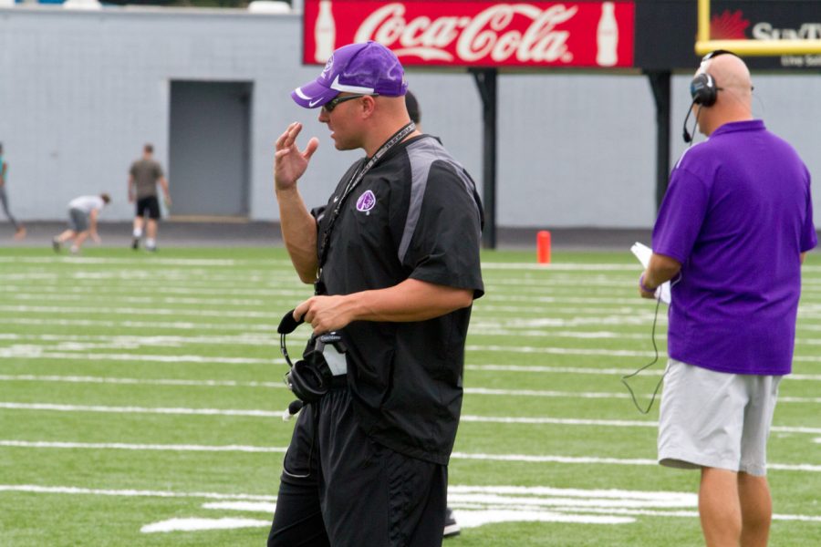 Brett Borden, defensive line coach, signals to players during the Aug. 18 scrimmage.
