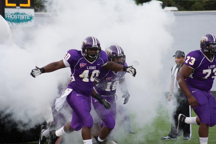 Eddrick Harris (#40) and fellow players Floyd Jones (#16) and Stephen Evans (#73) run onto the field before the Sept. 15 game against Kentucky Christian University. The Lions won 39-0, recording UNA’s first shutout since 2009.
