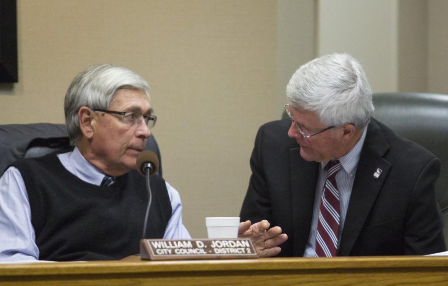 Councilman Dick Jordan confers with Councilman Barry Morris during the Jan. 8 city council meeting.
