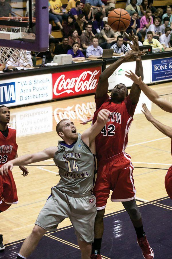 Junior forward Wes Long reaches up to block Union center Paul Valdor during the Jan. 12 home game. The UNA men went on to win the game 80-63.
