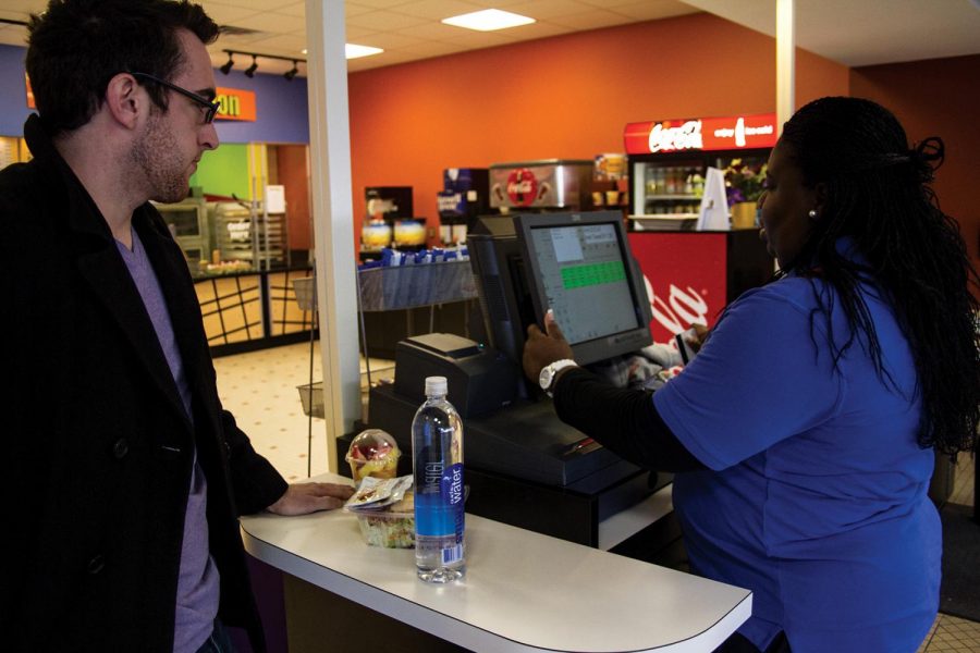 Student Jacob Keisler uses his MANE card to make a purchase in the GUC.
