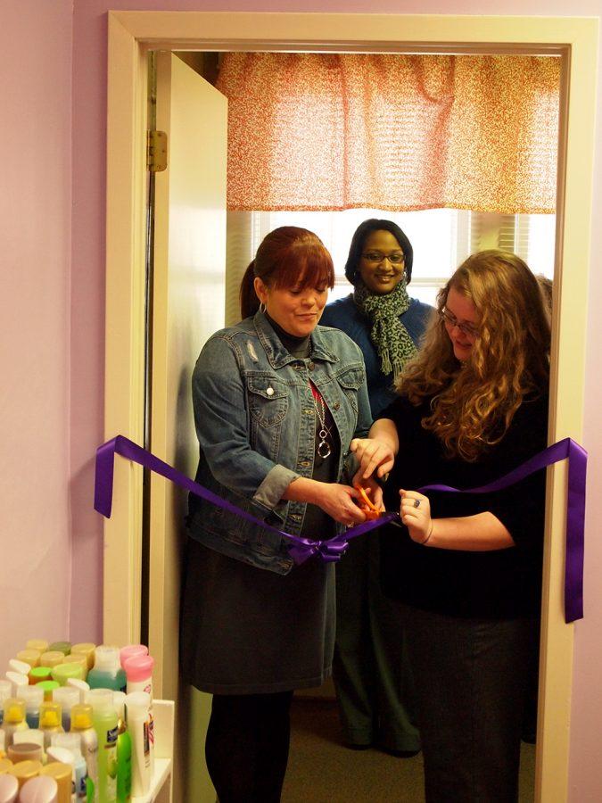 Jean Ann Willis and Genna Bradley cut the ribbon to officially open the Women’s Center’s Pride Pantry for Necessities Feb. 20. The pantry will provide personal items to UNA students, faculty and staff who are in need.
