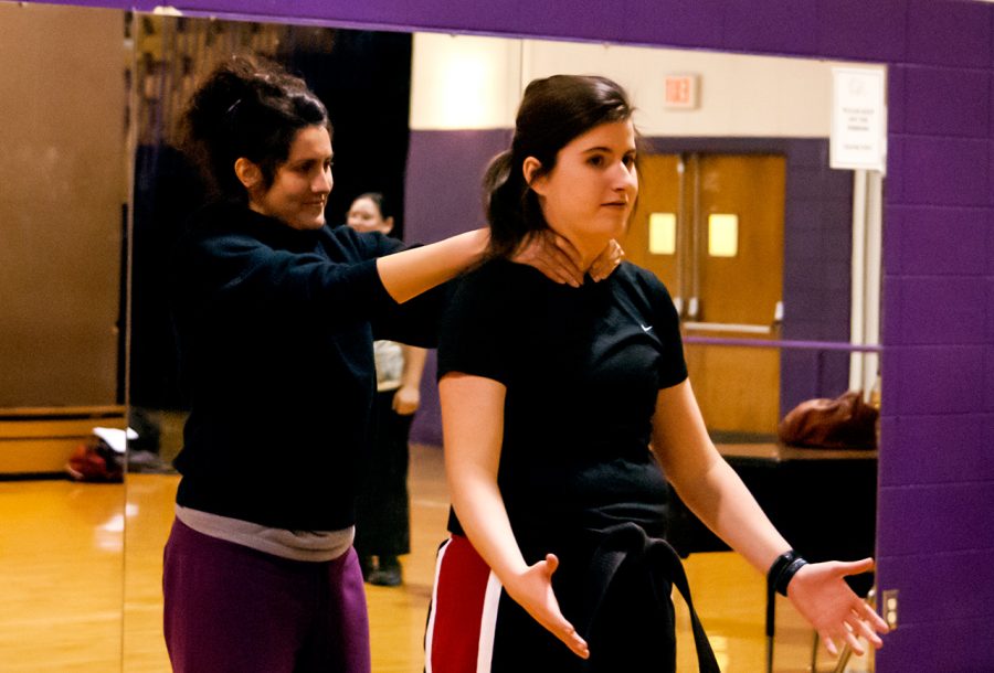 Senior Lauren Fulmer teaches a class of women how to break a neck hold from behind with partner Vanessa Gerig.
