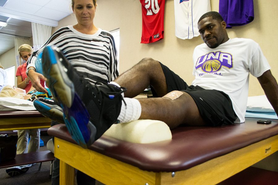 Chris Simpson works with a physical therapist at the North Alabama Bone and Joint Clinic last fall. Simpson and fellow player Nick Williams suffered ACL injuries during the 2012 fall scrimmage game and have been working towards hopefully playing for the Lions again in the fall of 2013.
