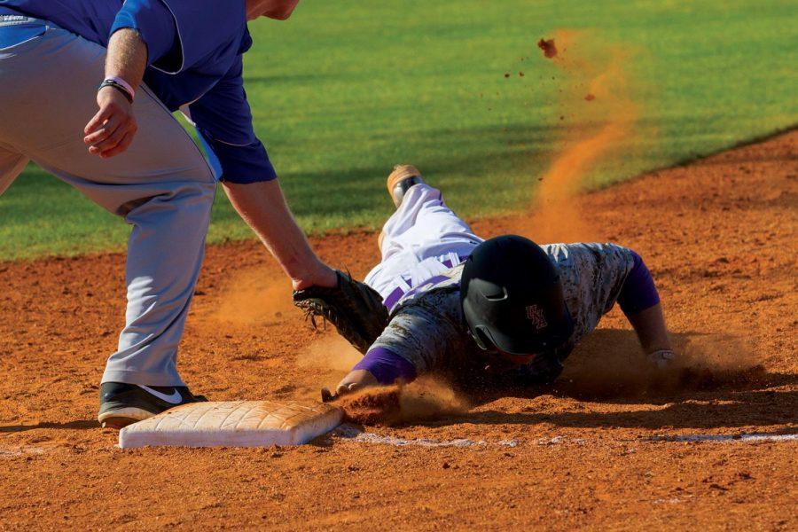 Outfielder Jake Ward narrowly makes it back to first base against UAH March 16.
