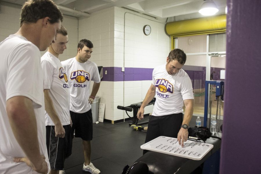 Members of the UNA golf team and Coach Stuart Clark work out in the weight room located in Flowers Hall. The UNA board of trustees approved $150,000 in university funds for the athletics department to build a new weight facility behind Hal Self Field House.
