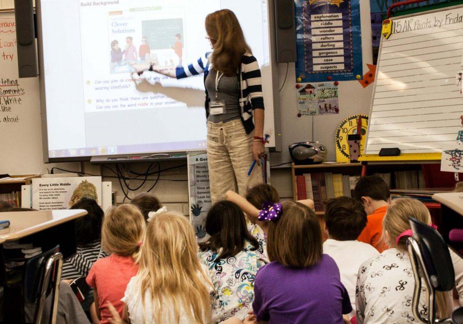 Student teaching intern Victoria Roberts teaches Mandy Wicks’ first grade class at Kilby School. Officials said they are trying to generate more funding internally to reduce the school’s financial pull on the university.
