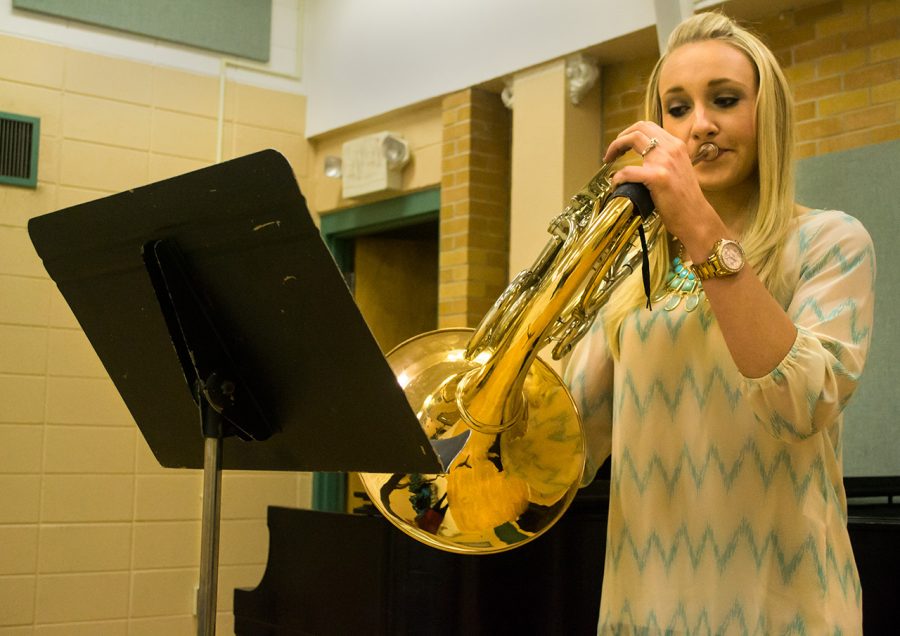 Alexis Cote, recent winner of the first place award in the orchestral brass caption at the Alabama Federation of Music Clubs competition, practices the French horn in the Music Building at UNA.
