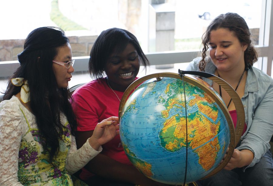 Lily Wallace, Owasra Ayassor and Demi Pan study a globe in LaGrange Hall. The Language Partner Program allows students to explore each other’s cultures,  gain global perspective and networking for the future.
