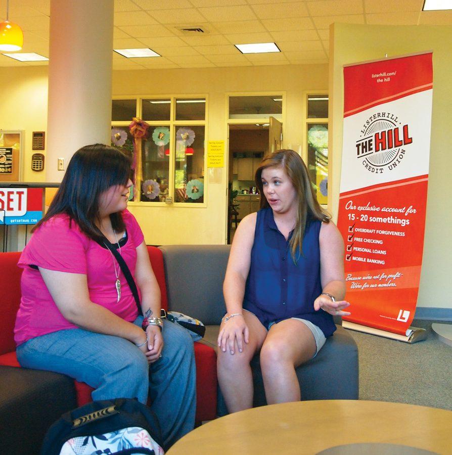 Angelica Espitia and Ashley Motes hanging out at The Hill, Listerhill Credit Union’s on-campus branch, located in Gulliot University Center. The Hill branch is operated by staff and student workers, and has features a lounge area for students.
