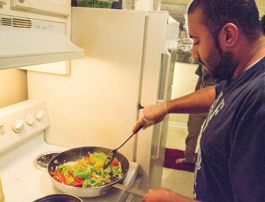 Student Ali Alderees prepares Gozee in Omar Bursais’ apartment. Arabic students cook cultural food in their homes, but embrace American food as well.