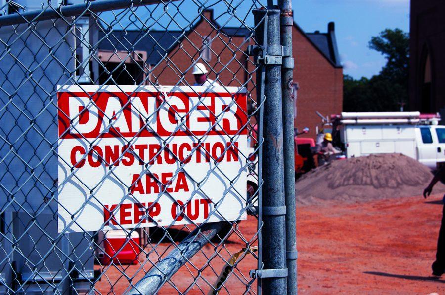 A sign at the entrance of the Academic Commons Building site prohibits individuals from entering. The building is scheduled to be completed in December, although potential weather problems could cause the date of completion to change.