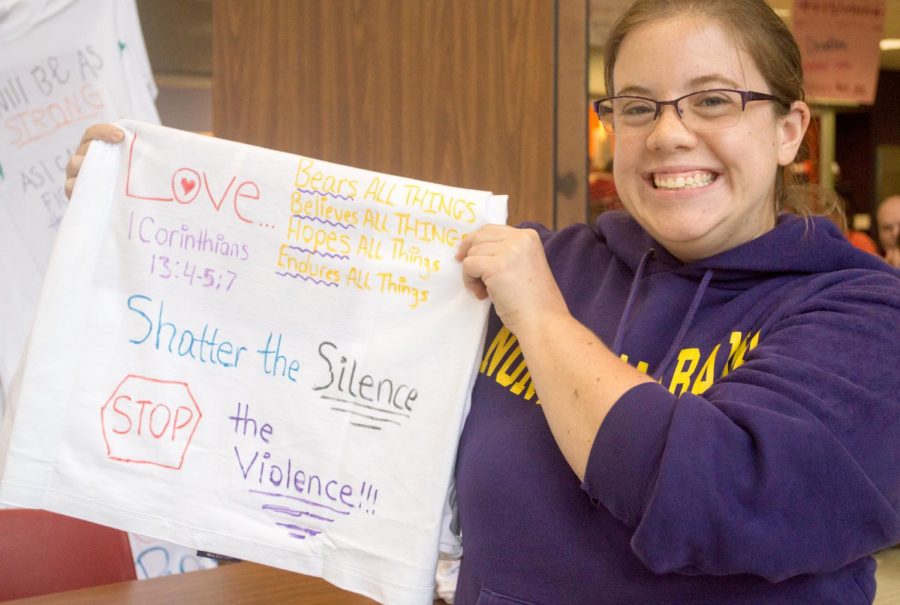 Junior Maegan Bradford holds up her shirt for The Clothesline Project which took place in the GUC Oct. 16.
