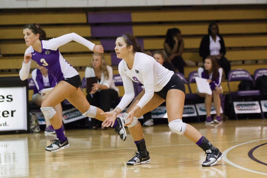 Hope Rayburn charges towards the net while Caroline Neisler waits for the ball in a 2012 UNA volleyball match. Rayburn played with Neisler from their sophomore year of high school to the 2012 UNA volleyball season.