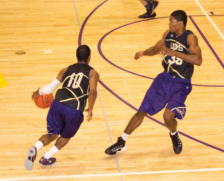 Tyler Pritchard looks for a play while teammate Calvin Dade back peddles to get into defensive position during a practice in October. The UNA men’s basketball season will begin in Huntsville against Stillman University on Saturday, Nov. 9 and continue against Fort Valley State University on Nov. 10.