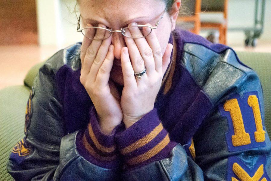 A student raises her hands to her face in grief over exam stress. You do not have to be this student — there are numerous ways to fight off exam-time stress.