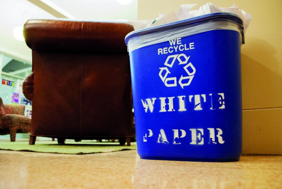 A recycling bin rests on the floor of a residence hall, filled to the brim with paper. The UNA Outdoor Adventure Club and SGA have partnered with the Florence Recycling Center to strengthen recycling efforts around campus. 