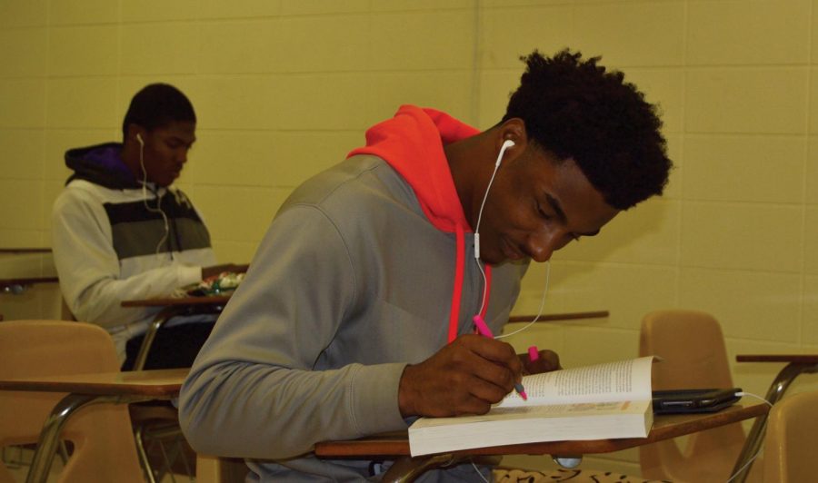 Student athletes Bruce Adams and Calvin Dade take a break from their practices for some studying.