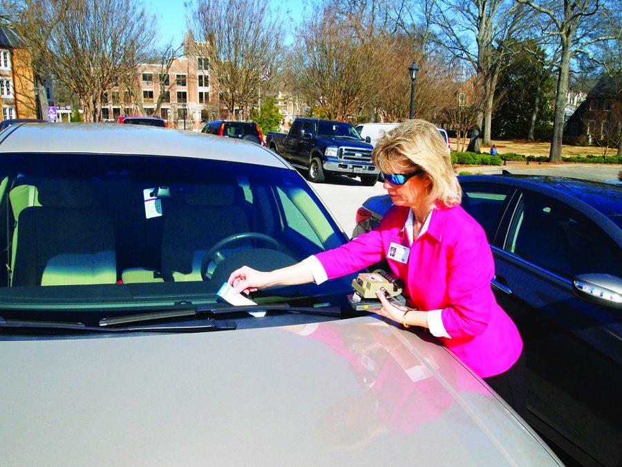 Former ADA Coordinator Lisa Reburn writes a ticket for a vehicle illegally parked in a handicapped spot in the spring of 2012, according to earlier reports in The Flor-Ala. UNA police have written 41 parking tickets for the same offense this year.