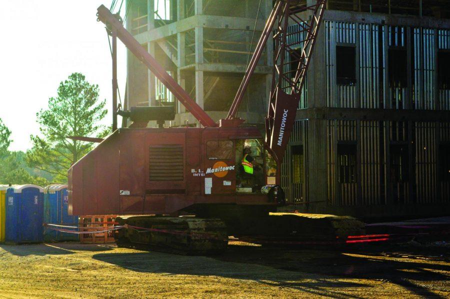 An employee of BL Harbert International construction company operates a crane at the site of the new science building. BLH spends an average of $2,000 on fuel each week for their machines, said project manager Dick Cassidy.
