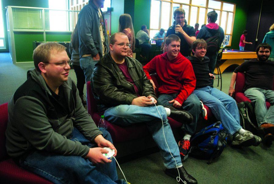 Students play video games at the Lion’s Den, the university’s game room. Kayla Wade, an attendant, said many of the students who come are regulars.