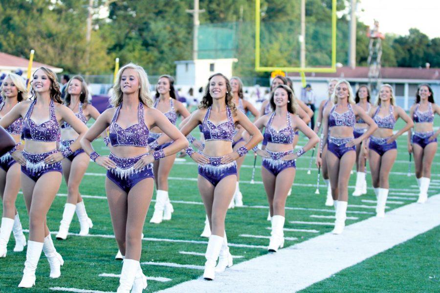 Members of the auxiliary line march during a performance at the Sept. 27 home game against Valdosta State University. The former mandate that the Lionettes and color guard members maintain 21.9 body fat percentage was suspended after a Title IX investigation began in August.
