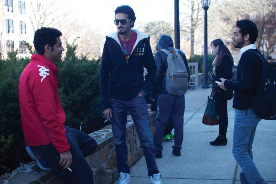 Students Hassan Al Ali, Ali AlMubarak and Mohammed Al Ali gather outside the GUC Jan. 16 to smoke while discussing the day’s events. SGA leaders have expressed intentions to present a campus smoking ban later this year.