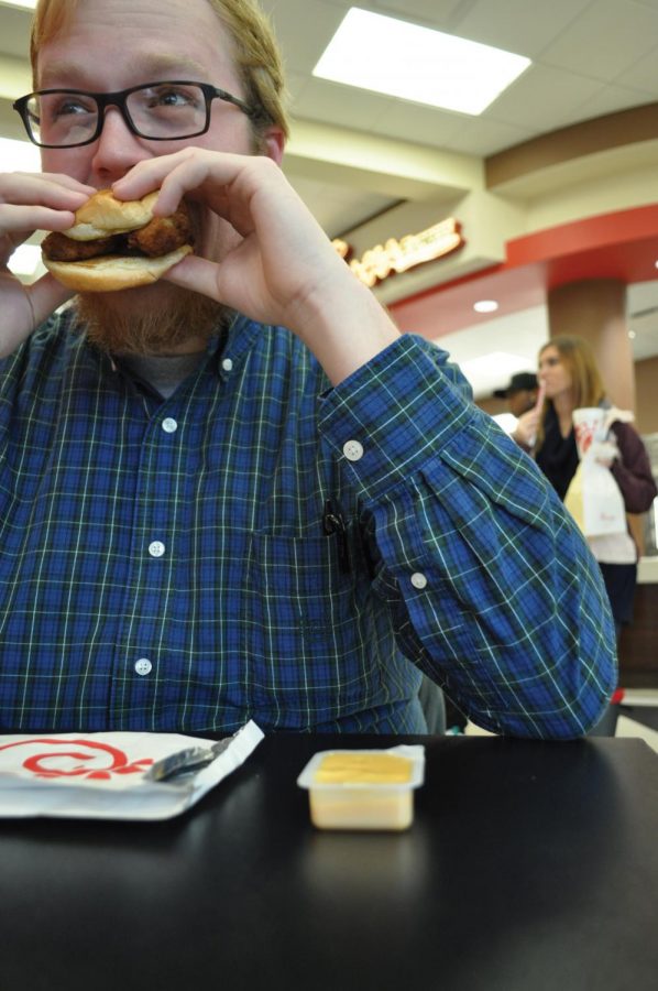 Junior Cory Moss eats a Chick-fil-A sandwich in The Commons Jan.12. Sodexo general manager Alan Kinkead said the restaurant will begin serving breakfast in February.
