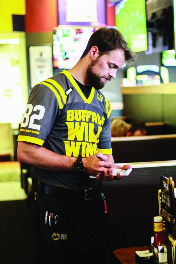 Junior Andrew Kerstiens waits a table at Buffalo Wild Wings Oct. 14. This photo accompanied an Oct. 30 article about sexual harassment in the workplace.