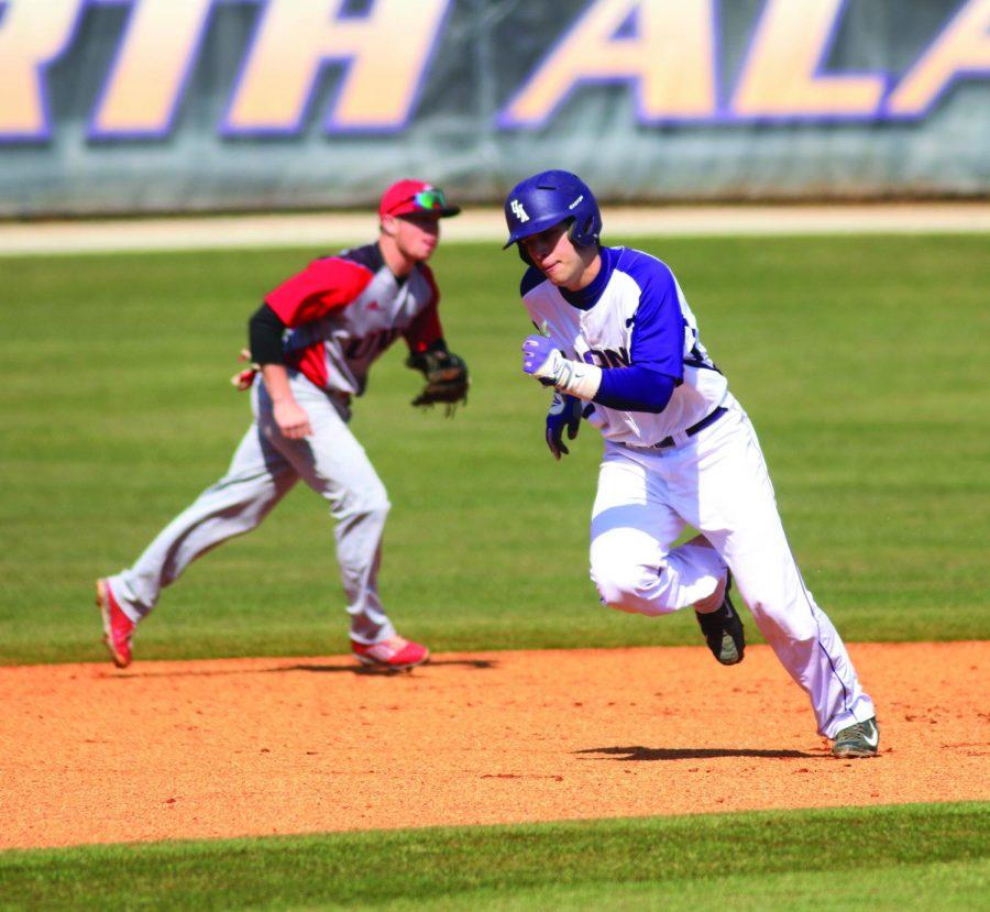 Junior catcher Kevin Hall runs to third base against the University of West Alabama Feb. 28. Despite having only one home run on the season, the Lions have scored by playing small ball. UNA leads the Gulf South Conference in stolen bases with 28.