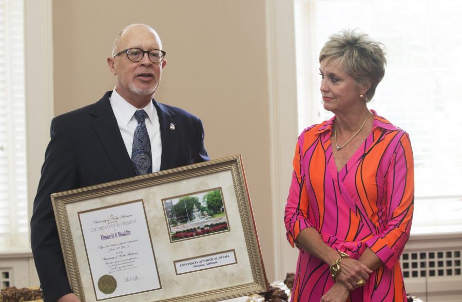 Vice President for Enrollment Management Thomas Calhoun presents a certificate of retirement to Kim Mauldin June 24. Mauldin serves her last day as director of admissions June 30.