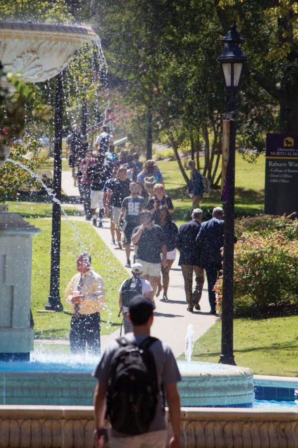 Students walk to and from the Commons Building on the crowded sidewalk in front of Keller Hall’s Raburn Wing Tuesday afternoon. Enrollment increased 3 percent this semester causing an increased number of students on campus.