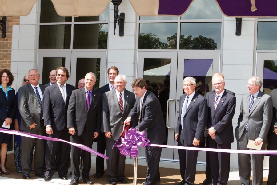 University President Kenneth Kitts, surrounded by the board of trustees and university officials, cuts the ribbon to mark the grand opening of the Science and Technology Building next to Kilby Laboratory School. The grand opening ceremony was held Sept. 10 at 1 p.m.